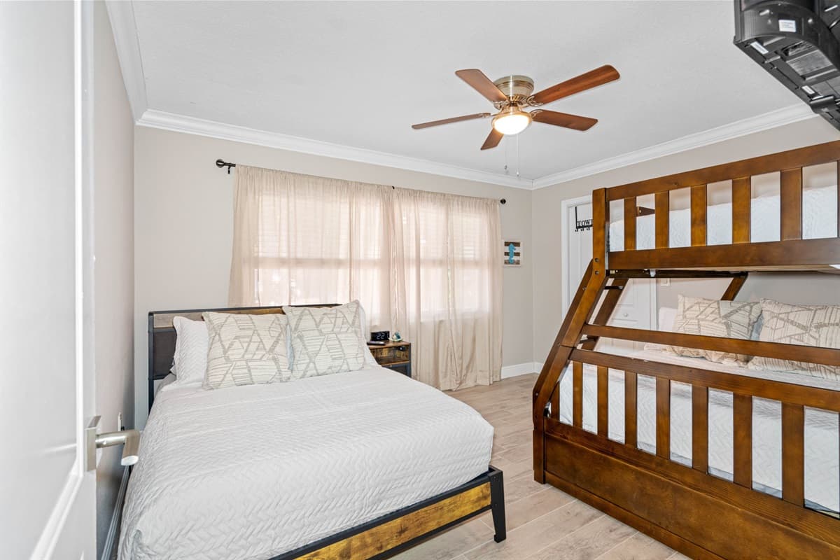 This spacious room features a cozy double bed, ideal for a restful night's sleep, along with a bunk bed and a trundle, providing additional sleeping arrangements that are perfect for kids or extra guests.