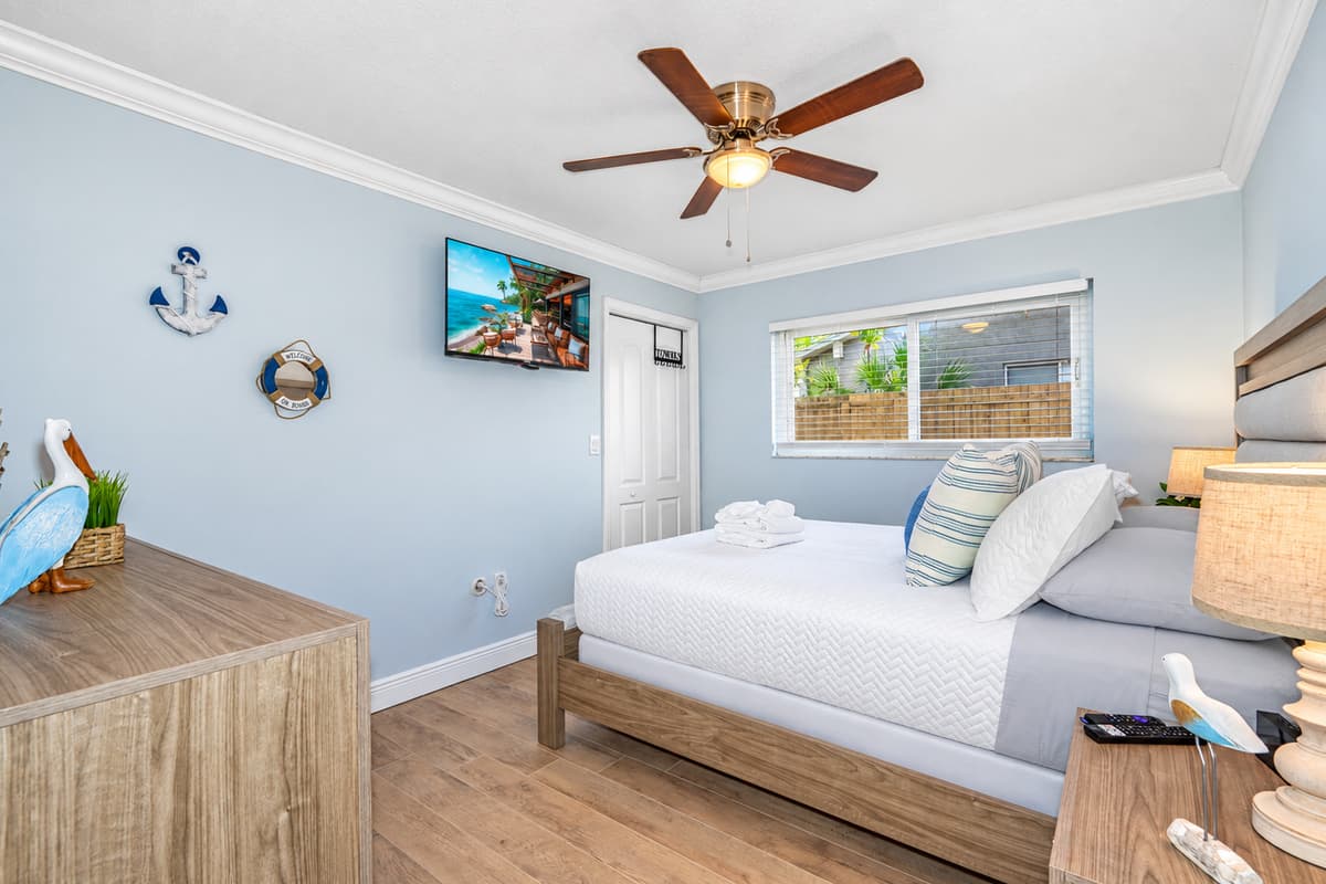 With its combination of cozy comfort and modern amenities, this bedroom offers a serene and inviting environment for a truly pleasant stay.