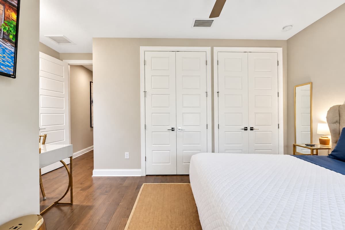 The room's neutral color palette, accented by rich textures and stylish decor, adds to the overall feeling of calm and comfort.