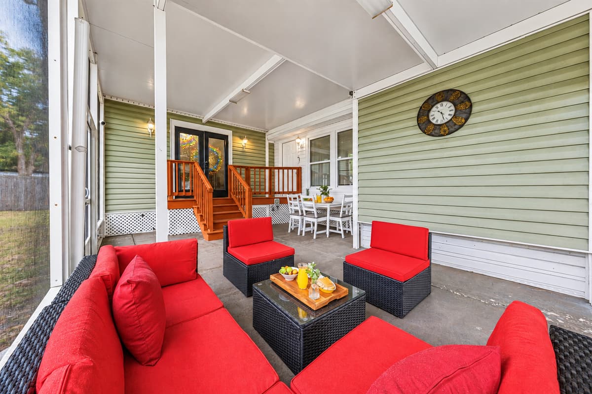 Covered outdoor patio with comfortable seating—ideal for relaxing and socializing.