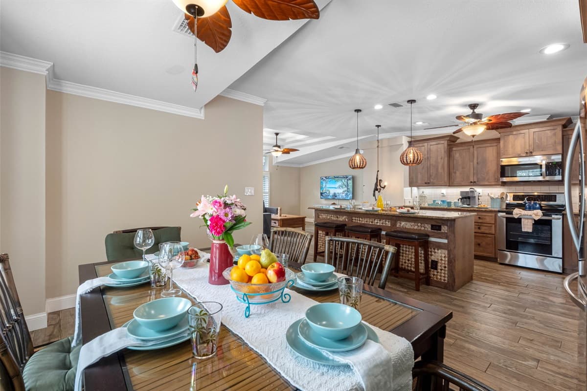The dining area flows seamlessly into the kitchen, making serving meals easy and convenient.