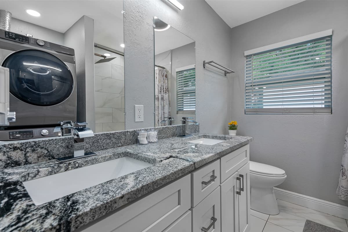 Stunning bathroom has his and hers sink, toilet, bathtub and a shower. Enjoy a relaxing bath after a long day of travel from your home to your home away from home. If you like this property, send us a message now!