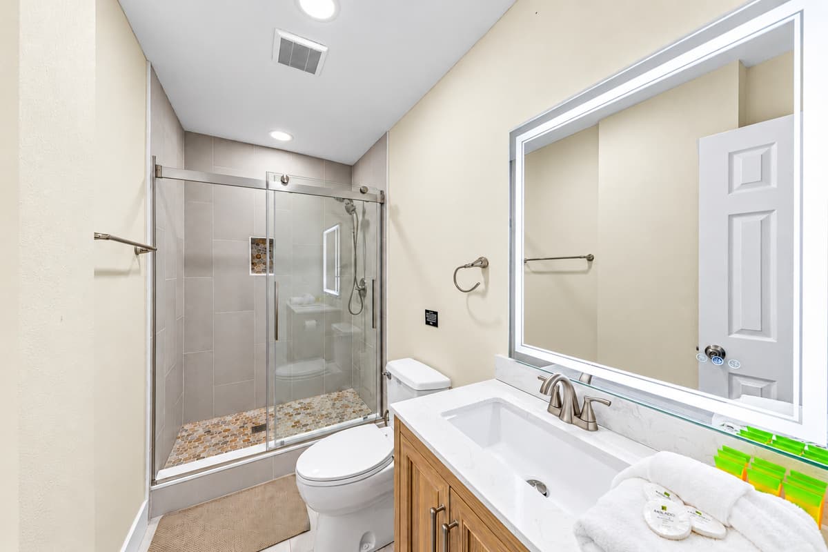 Clean, modern bathroom with a large vanity, bright lighting, and premium finishes.