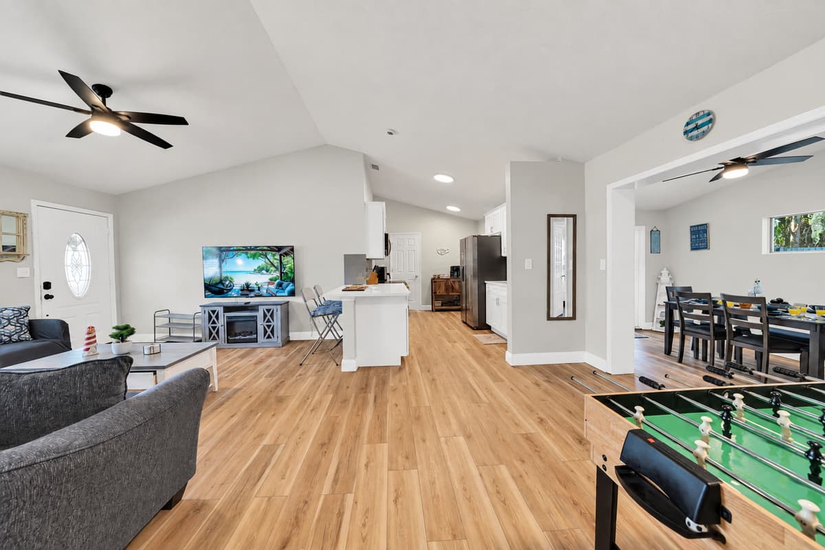 This is what eight guests actually need: room to spread out without anyone sitting on top of anyone else. An open floor plan, wood floors, plenty of seating and a foosball table sitting right in the middle of it all.