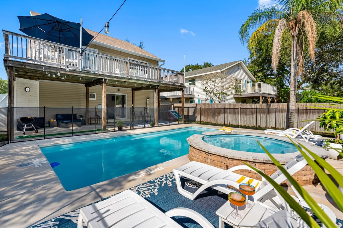 Your private escape awaits with a bright, open pool area, comfortable seating, and a fenced yard designed for both fun and relaxation.