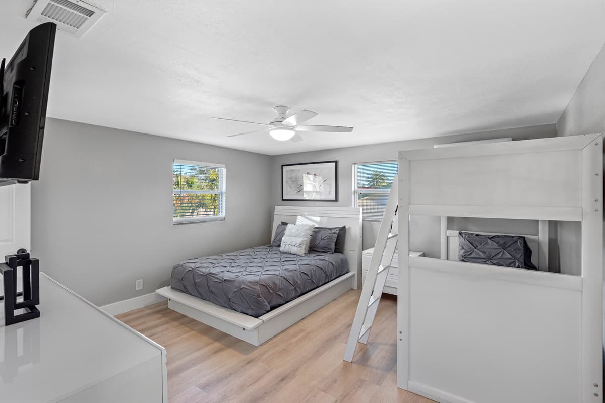 Elegant bedroom with queen sized bed, bunkbed, drawers for storage and smart TV. Ideal room for a group of friends or a family with kids.