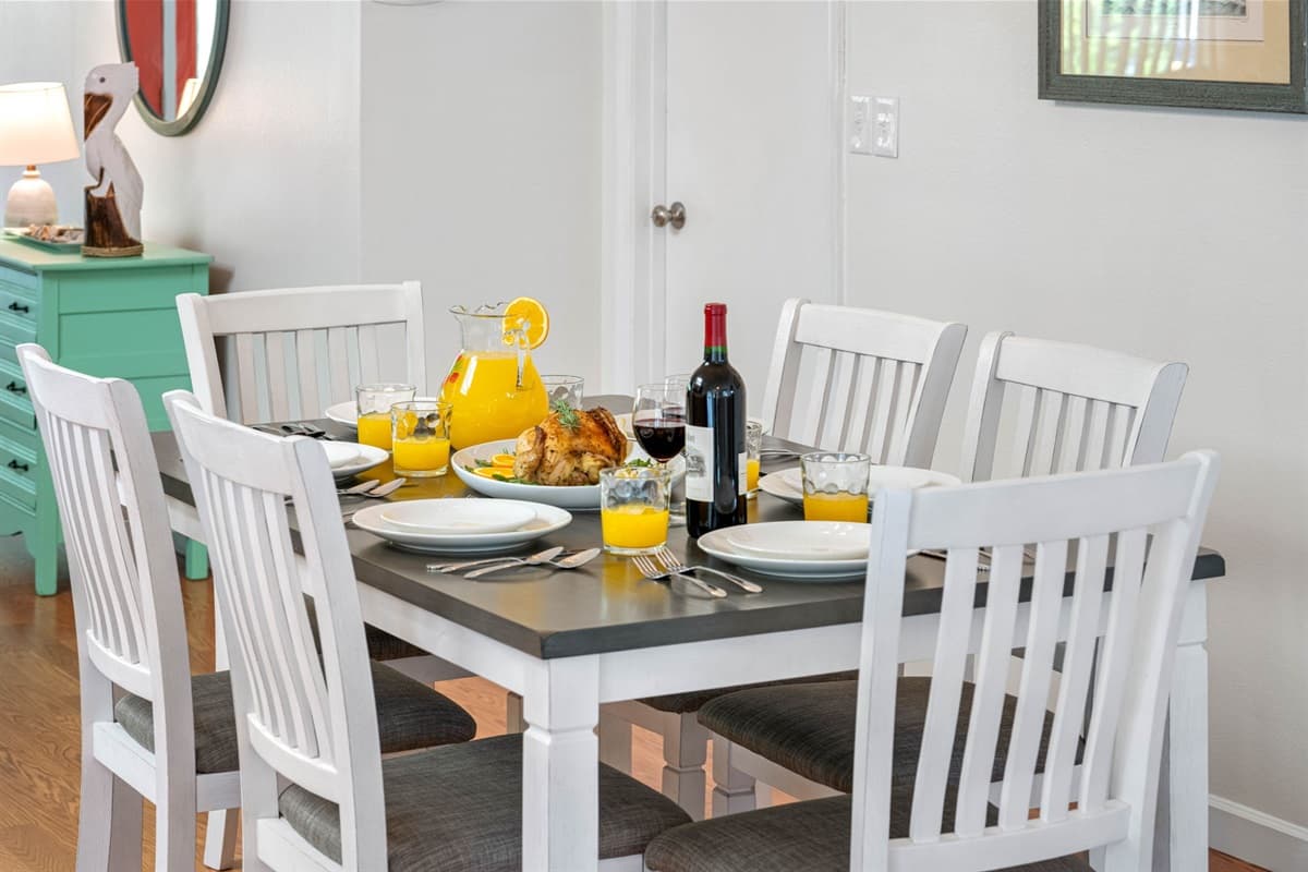 The table's design balances form and function, offering ample seating while maintaining a sleek profile that suits both casual dining and more formal occasions.