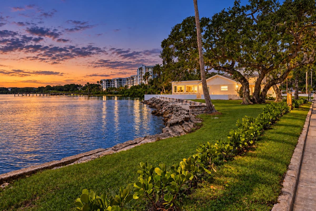 Waterfront side of the home with evening lighting.