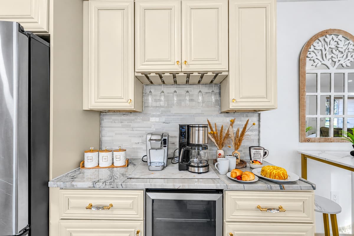 The kitchen features a beautifully styled coffee nook—perfect for slow mornings, fresh pastries, and your favorite brew.