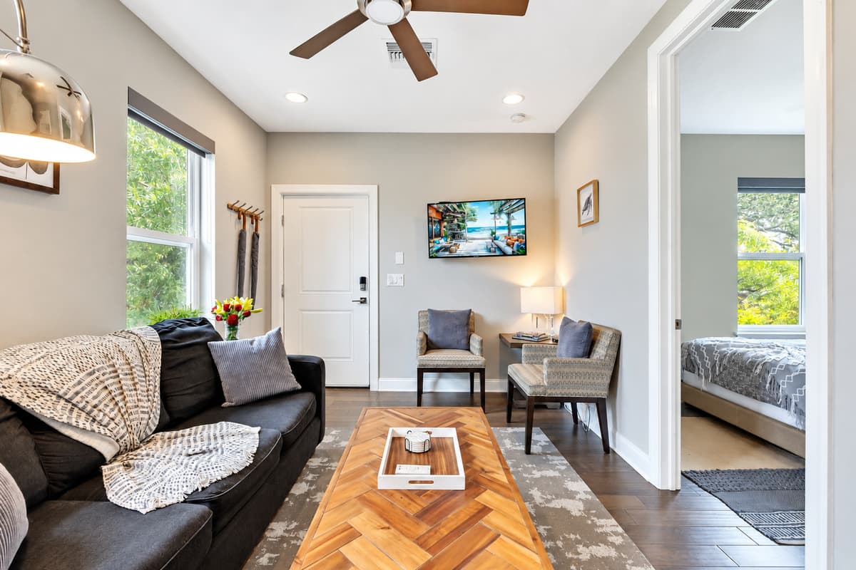 Large windows adorn the walls, allowing natural light to flood the room and bathe the space in a warm, inviting glow.
