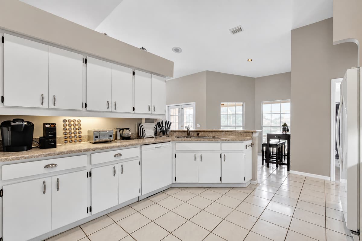 The classic white kitchen cupboards and the attention to detail in every element reflect a harmonious blend of style and functionality.
