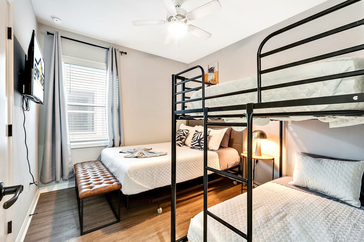 At the heart of this thoughtfully designed space is a sumptuous queen-size bed, adorned with soft linens and an array of pillows, beckoning you to a night of tranquil repose.