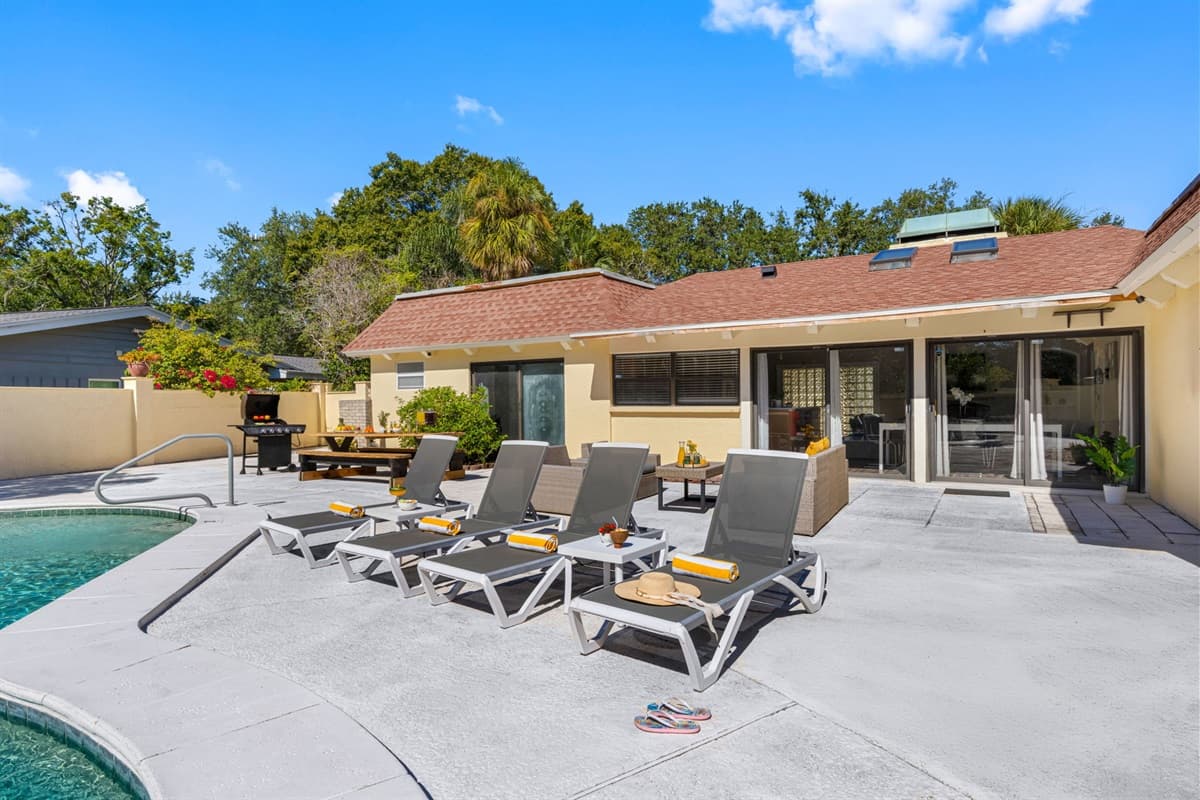 Host, relax, or celebrate — this backyard has it all: plenty of seating, a grill, and a refreshing pool to keep everyone happy.