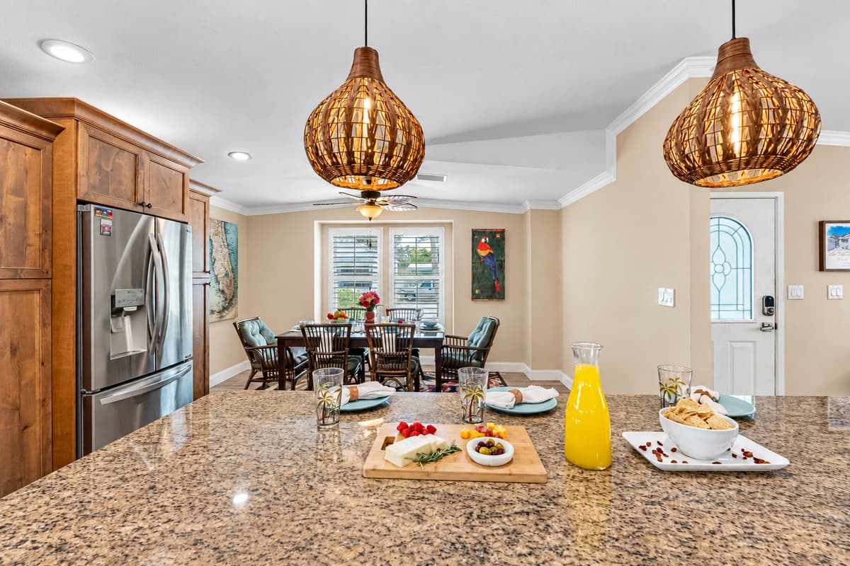 Cook with ease in a well-designed kitchen featuring granite countertops, tile backsplash, and deep sink overlooking the yard.