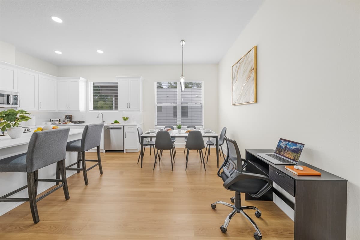 Wide view of kitchen and dining layout highlighting open-concept design.