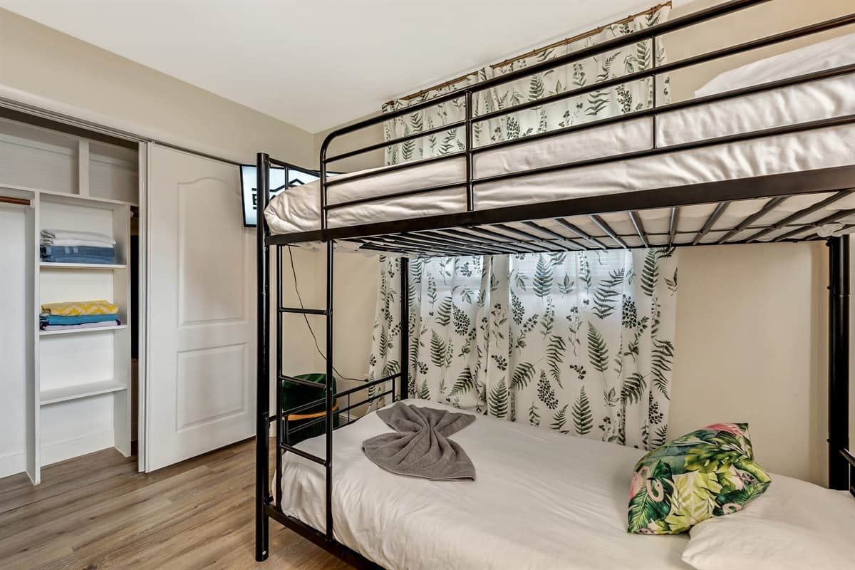 The bunk beds are thoughtfully arranged to optimize space while providing comfortable sleeping arrangements for up to four guests.