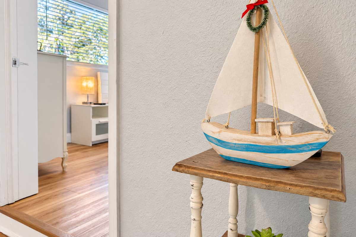 Small coastal touches turn up all over the house — a sailboat here, a lantern there. None of it is showroom staging; it's the kind of detail that makes a rental feel like somebody's actual home on the Gulf Coast.
