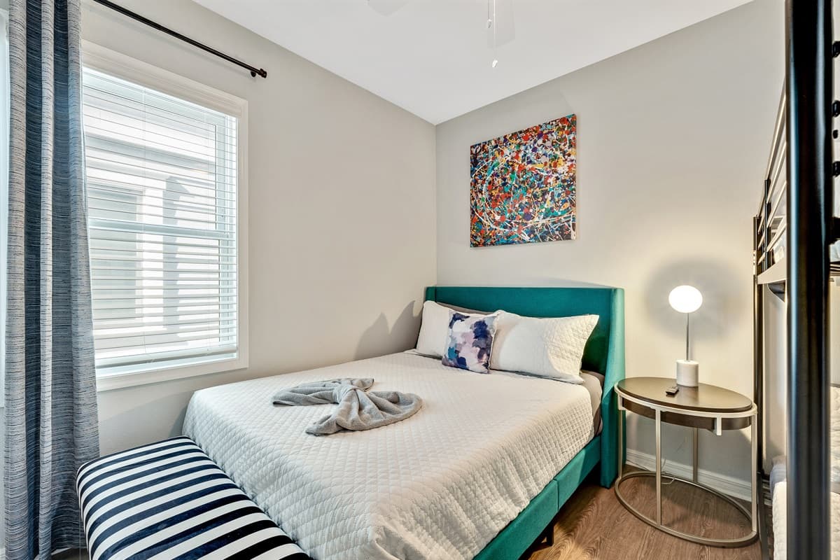 The queen-size bed provides a comfortable retreat, while the bunk bed introduces an element of fun and functionality.