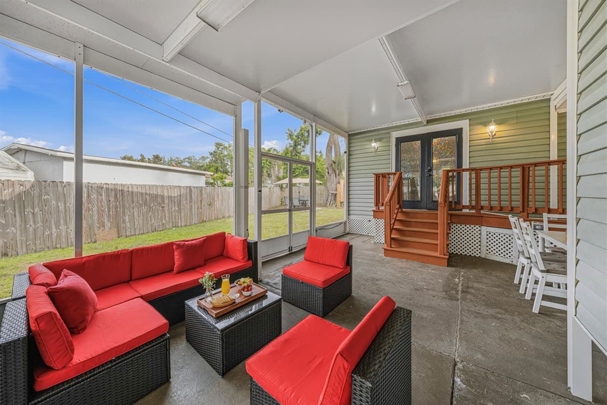 Inviting screened patio with plush seating and easy access to the backyard.