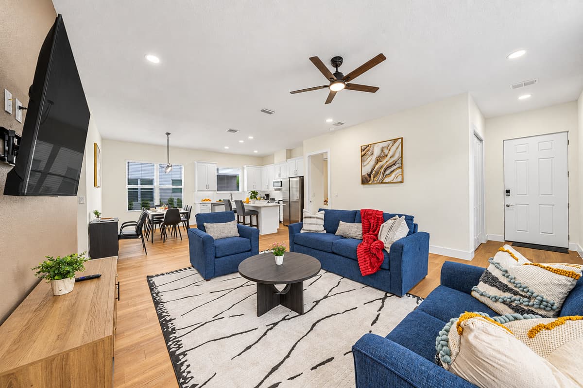 Spacious living room with cozy seating, large TV, and contemporary décor for relaxing.
