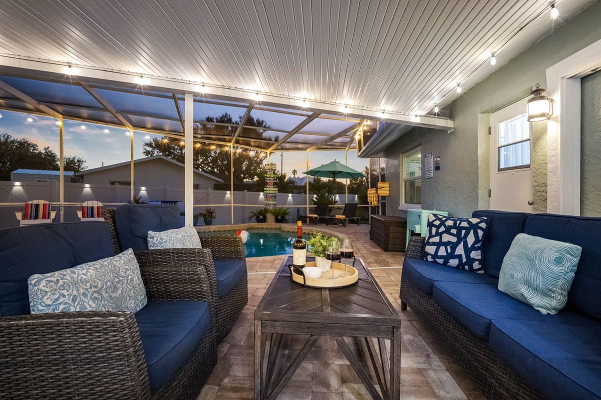 Sink into the cushioned outdoor furniture and soak in the serene view of the sparkling pool — where relaxation comes naturally.