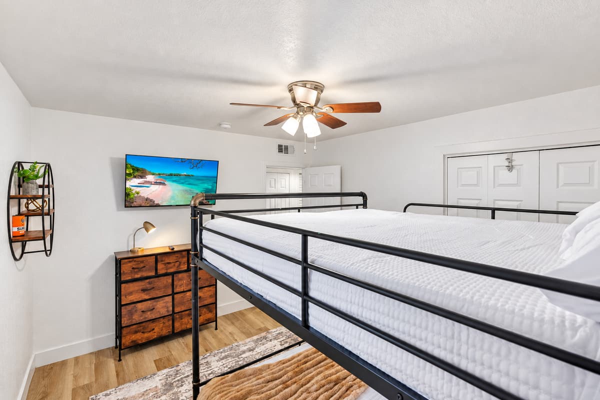 Perfect for kids or friends, this cozy bunk room features a full-over-full setup with clean lines, warm accents, and plenty of natural light.