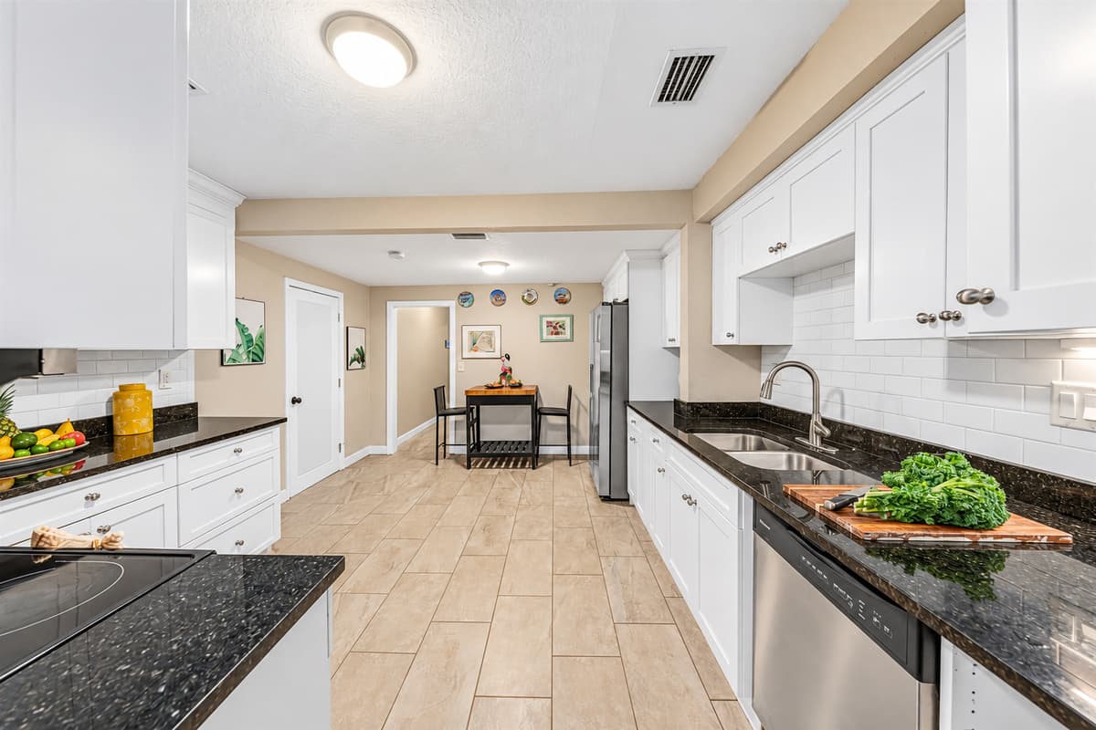 Spacious galley-style kitchen with extended countertops and easy access to dining area.
