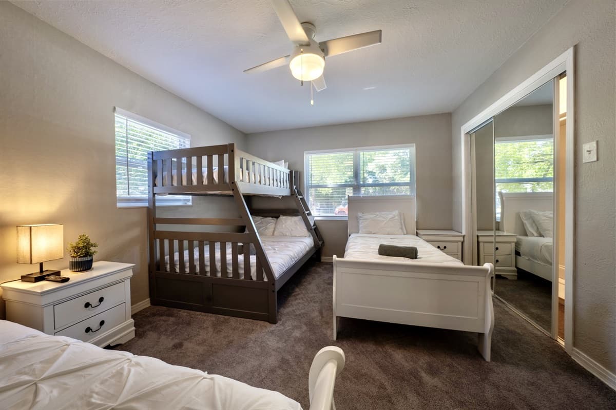 In this spacious bedroom, you'll find two comfortable twin-size beds along with a bunk bed, making it an ideal space for families, friends, or guests who prefer their own sleeping arrangements.