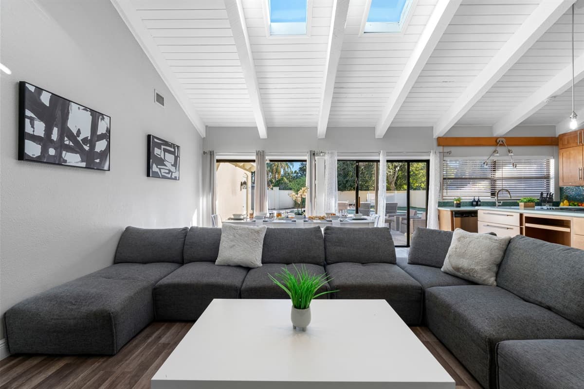 Bathe in natural light from the skylights and large sliding doors that open to the pool patio — indoor and outdoor living at its best.