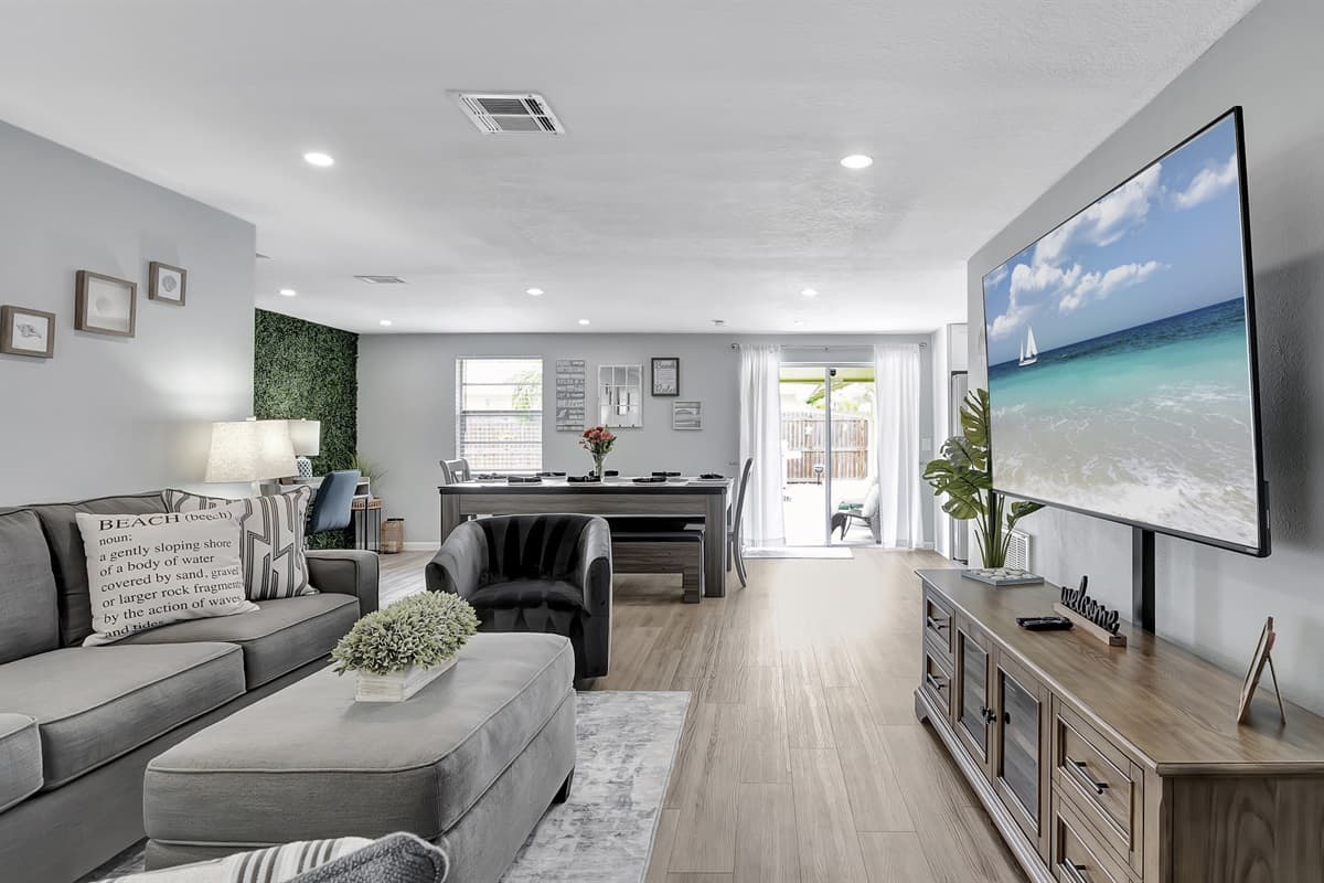 The centerpiece is a sumptuously comfortable grey couch and matching ottoman.
