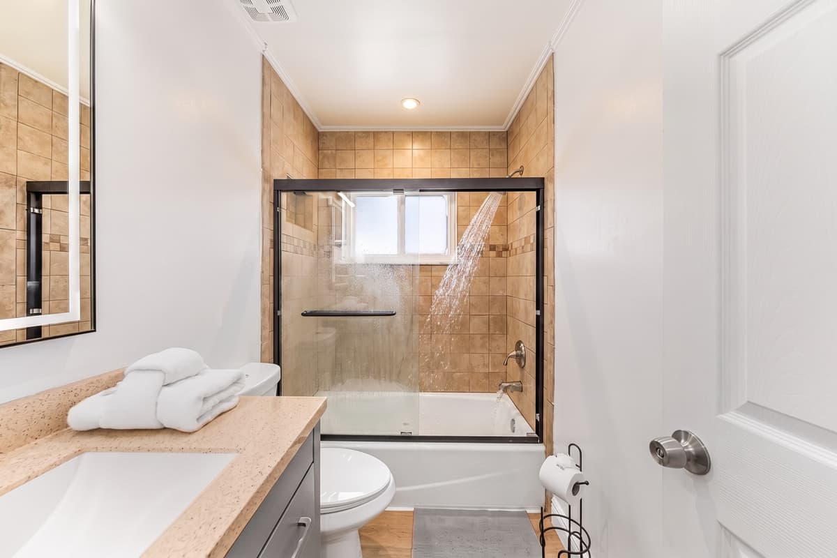 With a shower/tub combo and plenty of counter space, this bathroom works perfectly for families or groups.