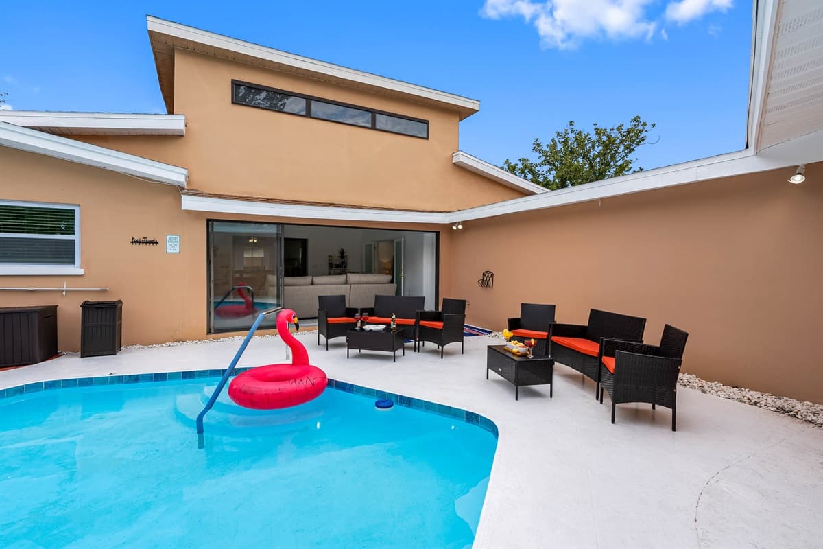 Surrounded by tropical landscaping and string lights, this poolside oasis is perfect for both sun-soaked afternoons and magical evenings.
