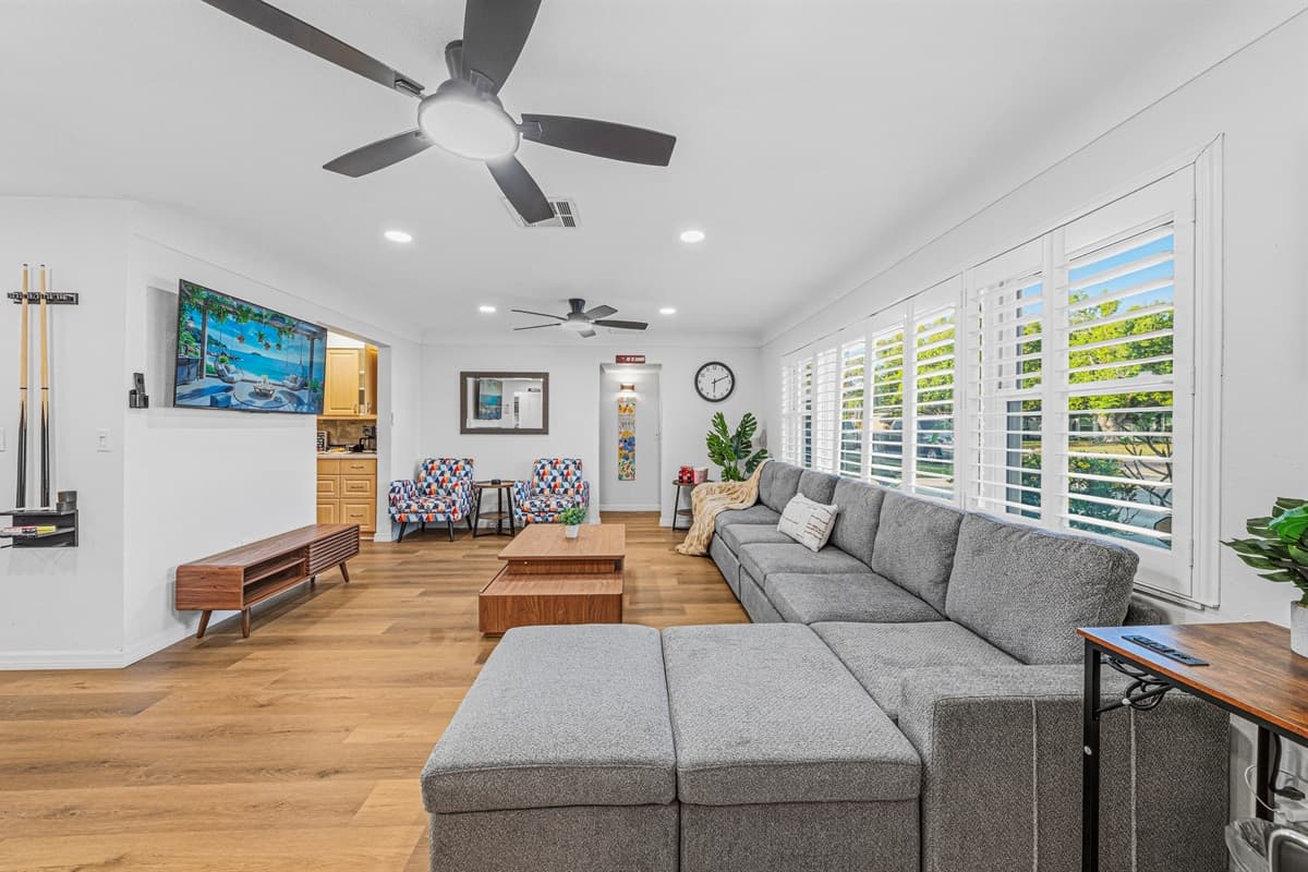 Bright and spacious living room with comfortable seating and smart TV—ideal for relaxing together 