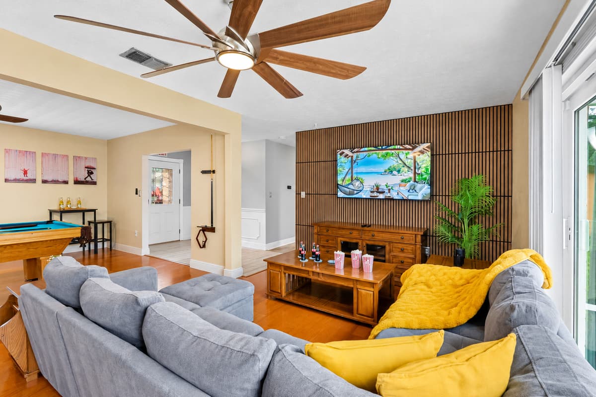 Bright and airy living space with seamless flow to the dining and game areas.