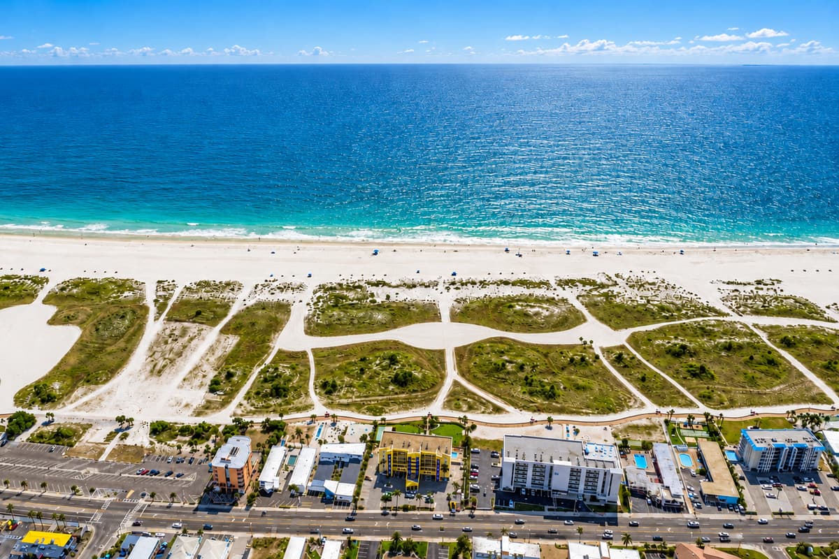 Top-down aerial view of the waterfront neighborhood with canal access and nearby homes.