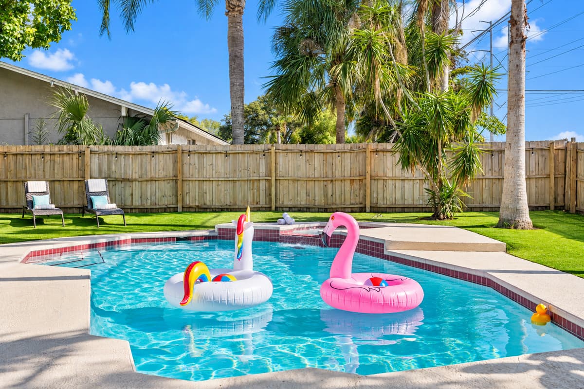 The pool itself is expansive, offering plenty of space for swimming, splashing, or simply floating on the crystal-clear water.