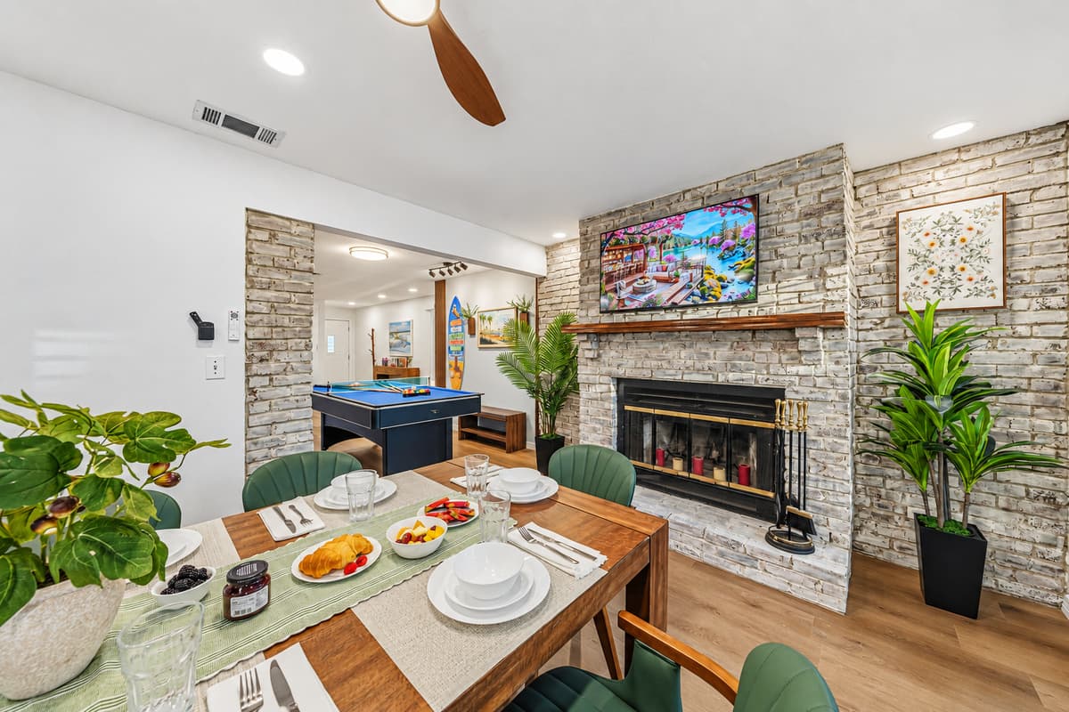 Elegant dining setup with fireplace backdrop—ideal for shared meals and memorable moments 
Table settings and food are for staging purposes only and are not included.