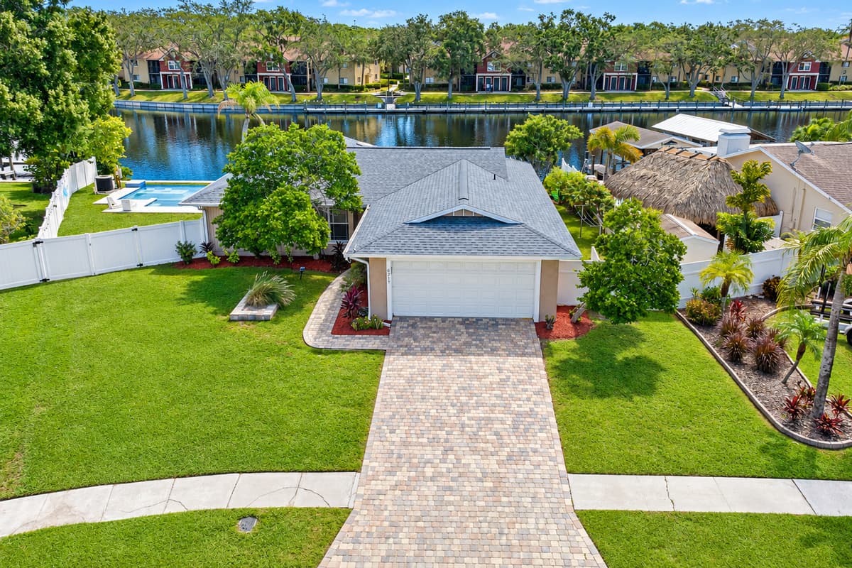 Incredible aerial front view of the house showcasing our beautiful front yard with trees and cute plants and our spacious driveway. If you are interested in this property, don't hesitate to send us an inquiry as soon as possible!