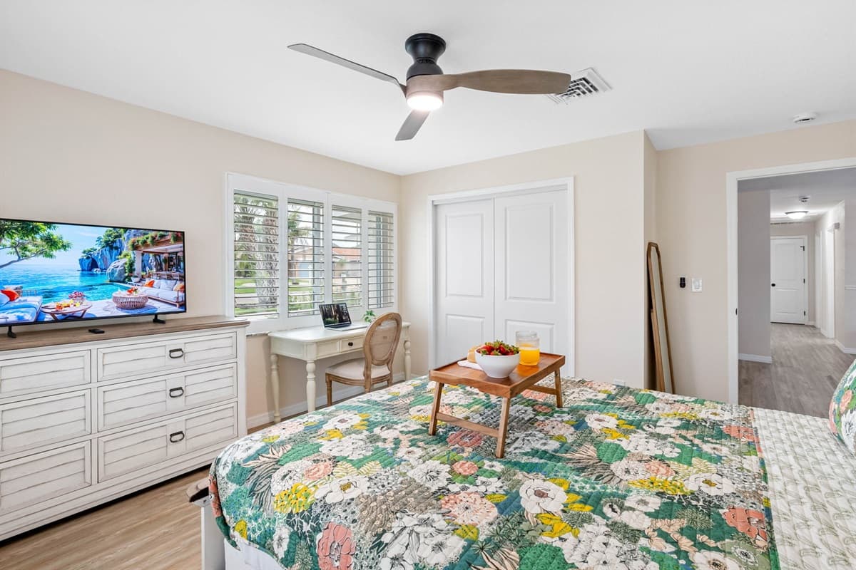 This room comes equipped with a flat-screen TV, dresser storage, and a ceiling fan to keep you cool and entertained.