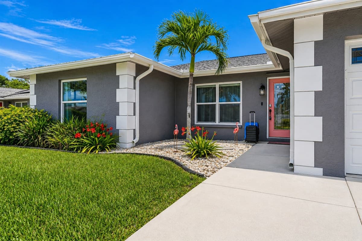 Charming front exterior with lush landscaping and a welcoming entrance.