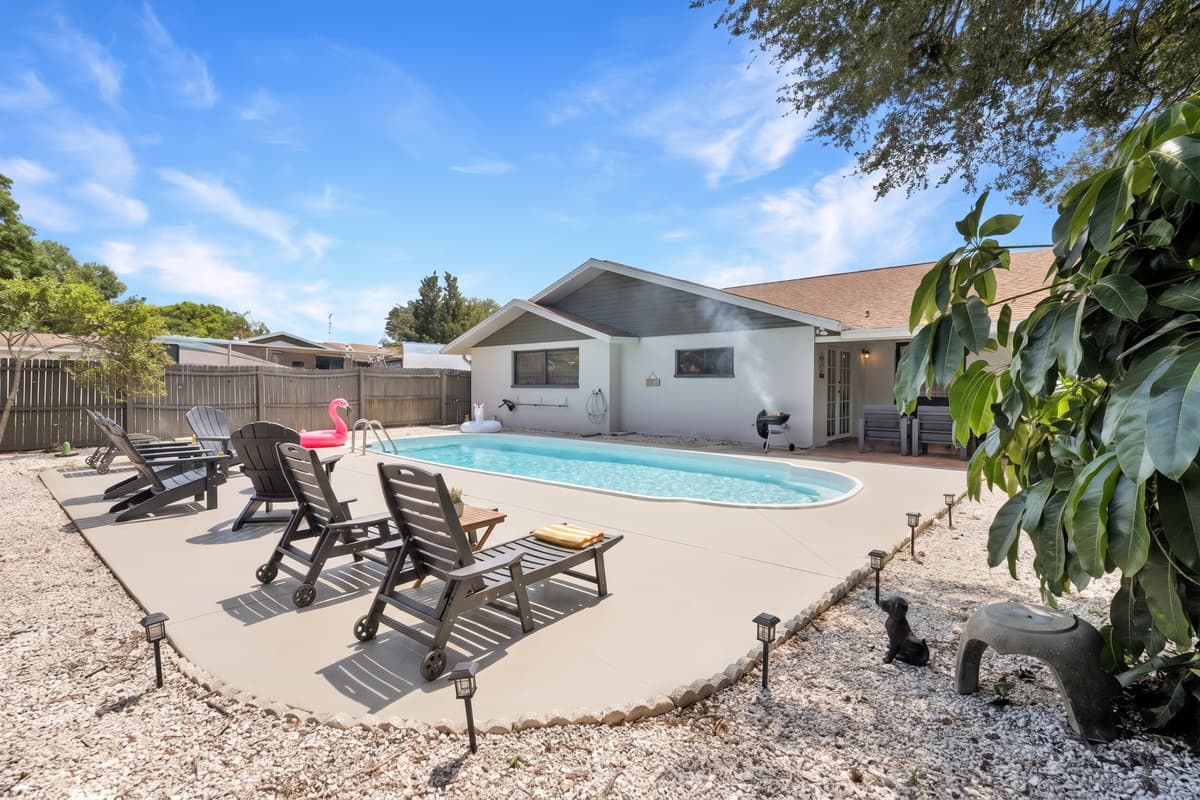 You can almost smell this one. The grill is going, someone is still floating in the pool, and dinner is happening about fifteen feet from where everyone spent the afternoon. Nobody has to change clothes or drive anywhere.