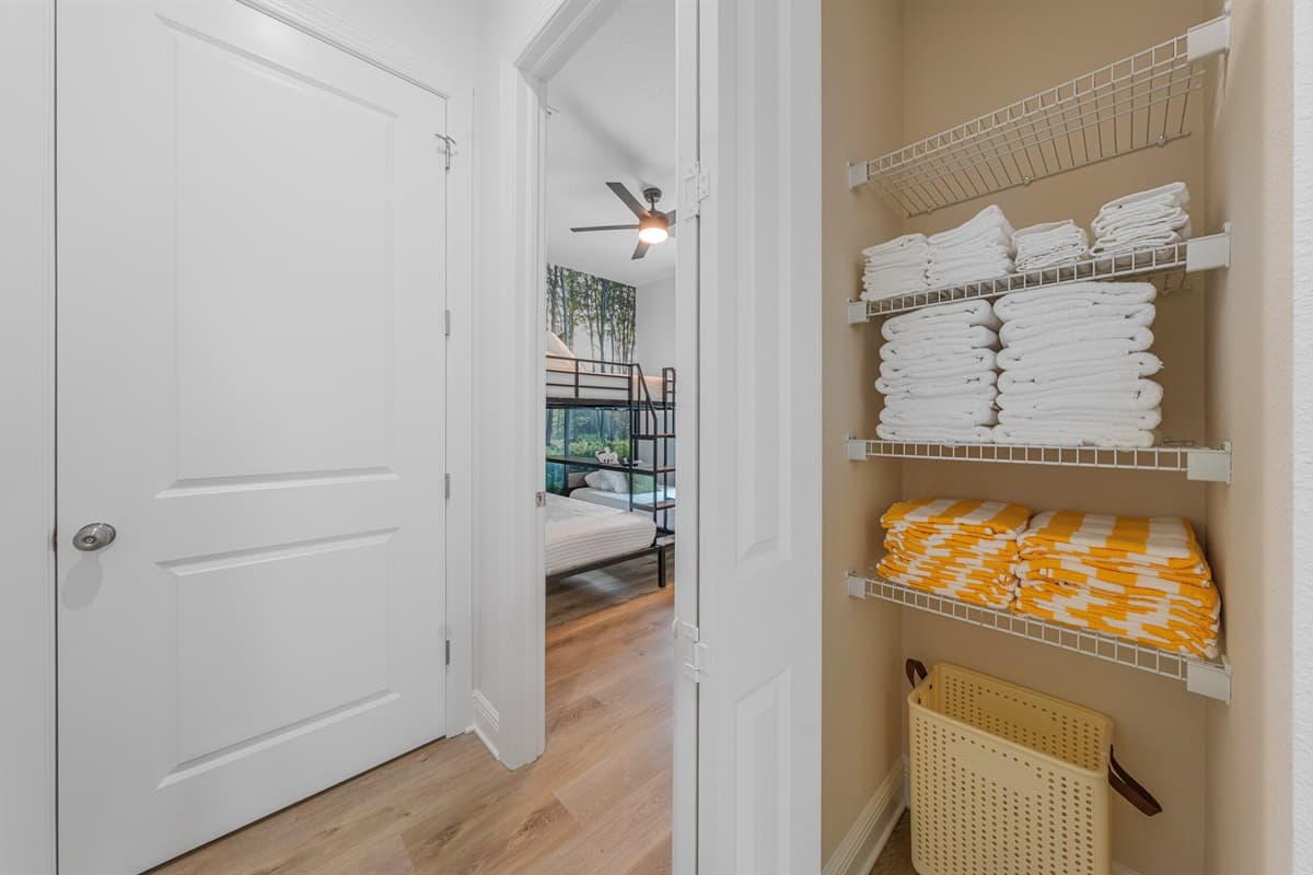 Linen closet stocked with fresh towels and essentials for guest convenience.