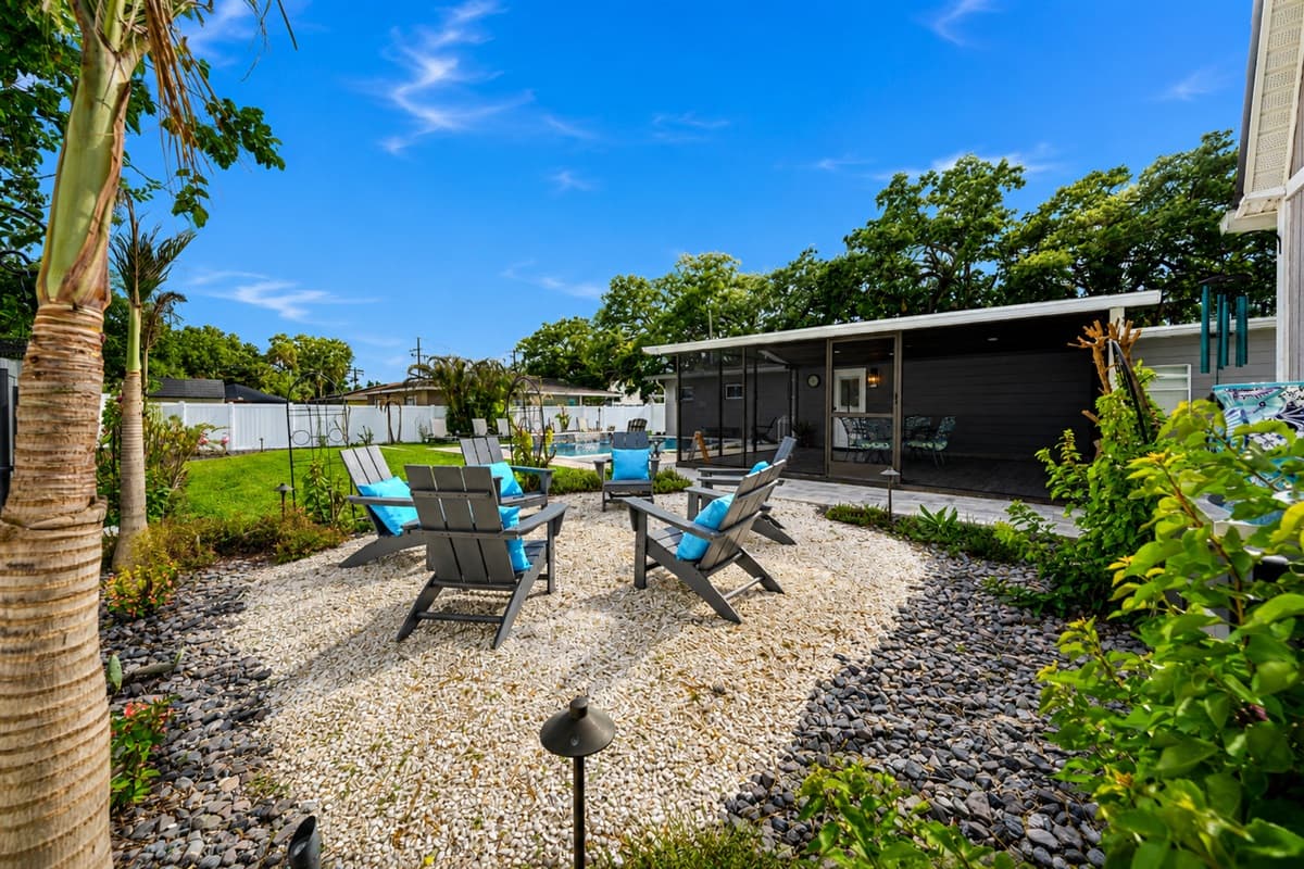 Beautifully landscaped outdoor corner with charming garden accents and backyard seating area.
