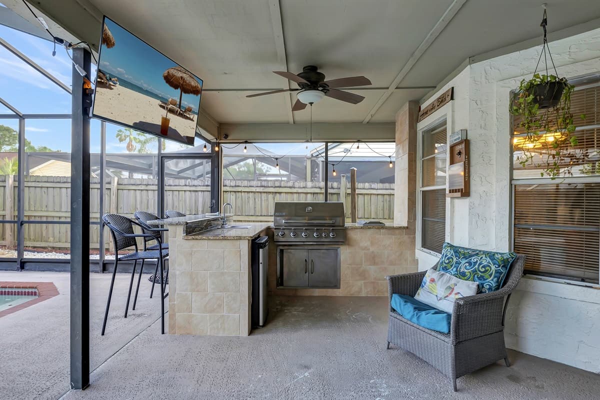 This is our patio area,  inviting seating arrangements for your comfort and a compact outdoor kitchen equipped with a grill.