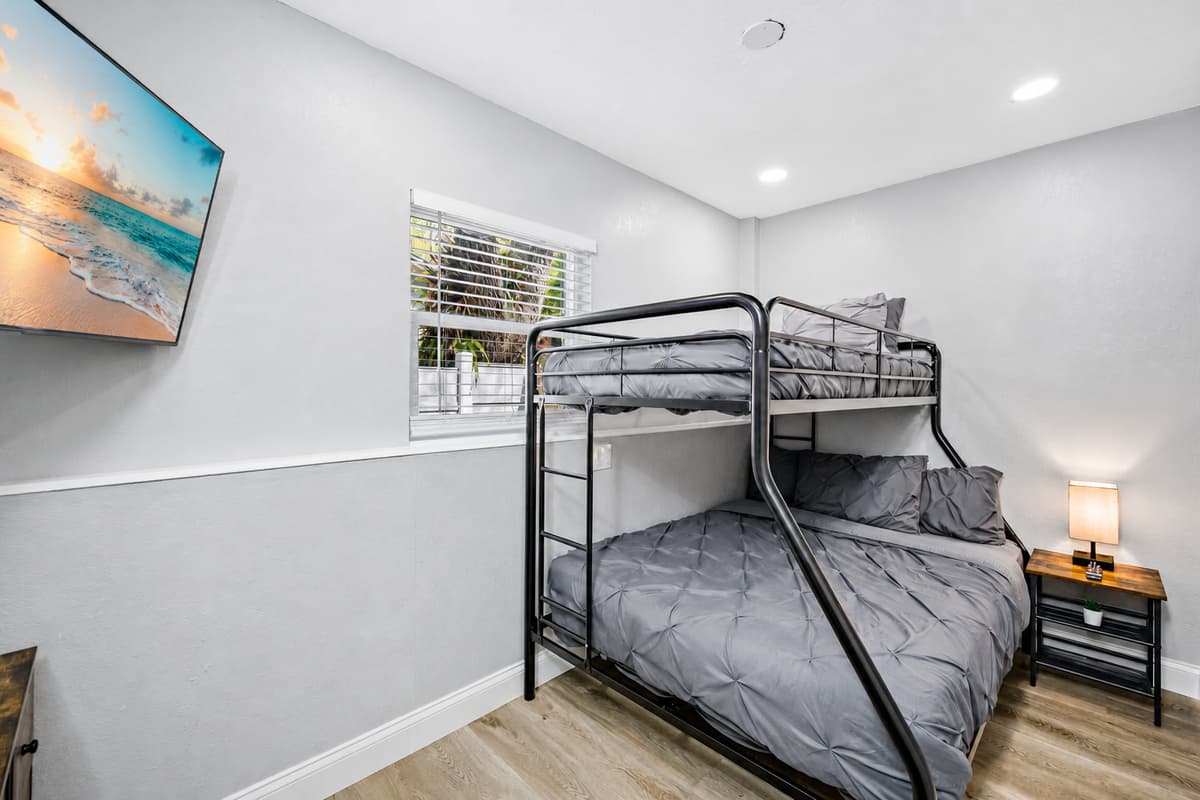 This beautiful room has a single over twin bunkbed, drawers for storage, and its own smart TV!