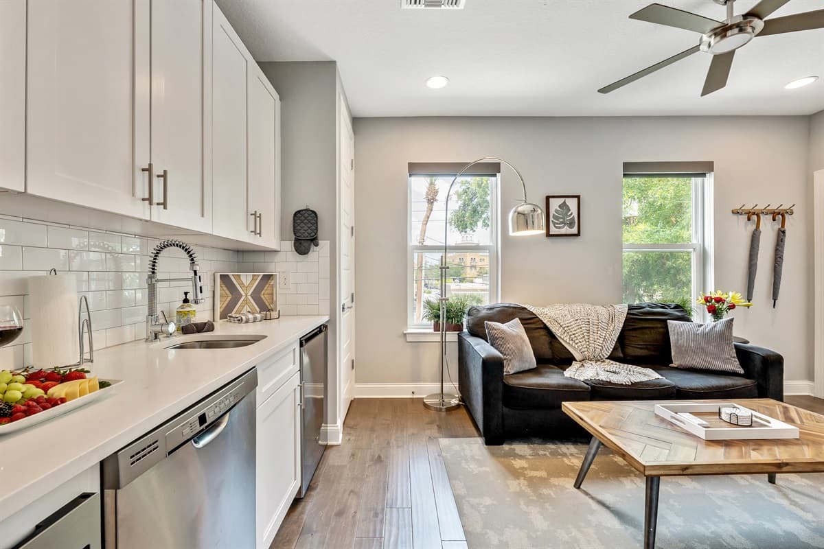 Large windows adorn the walls, allowing natural light to flood the room and bathe the space in a warm, inviting glow.