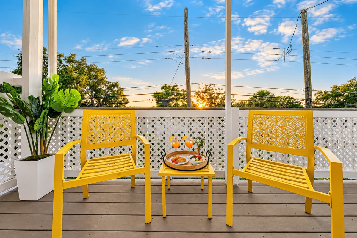 Close-up of outdoor seating setup with decorative touches for a relaxing vibe 
Food and drinks shown are for staging purposes only and are not included.