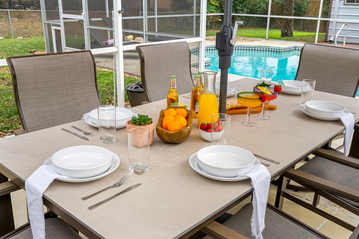 Gather around the table for unforgettable meals in this beautifully designed screened lanai.