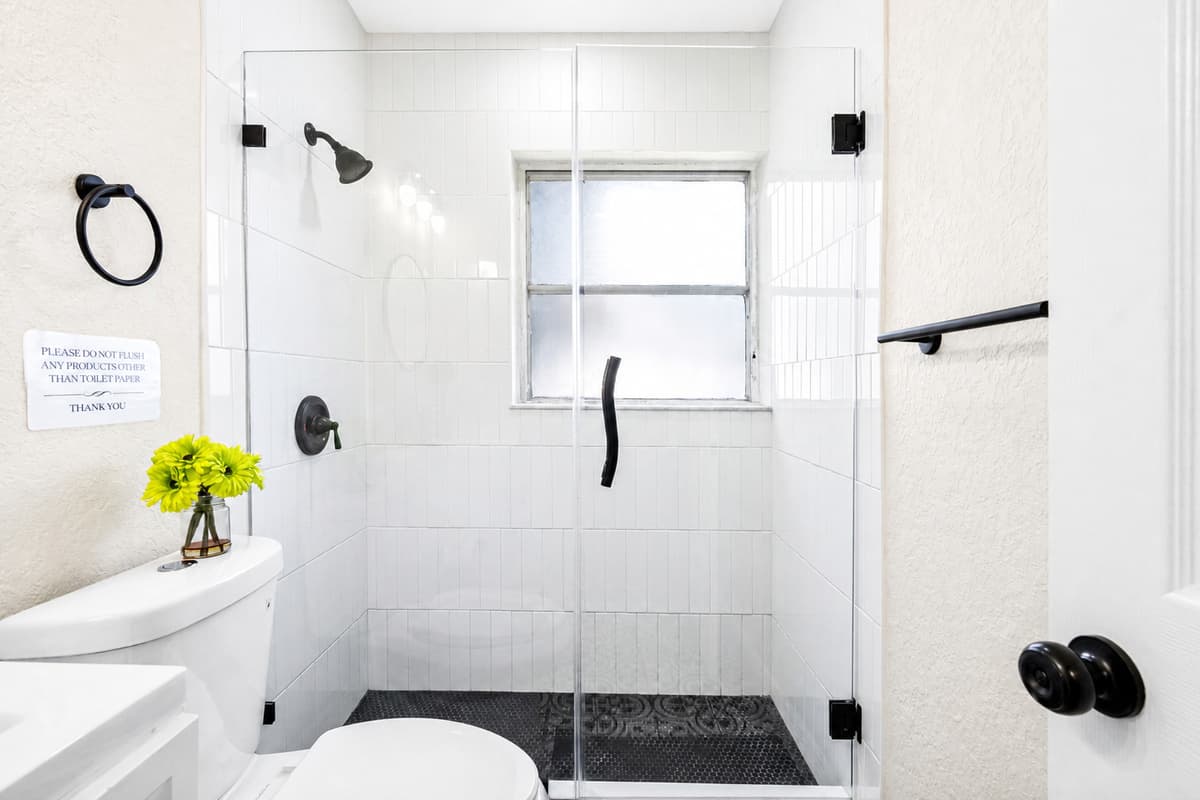 A frosted privacy window allows natural light to stream in while keeping the space discreet and serene.