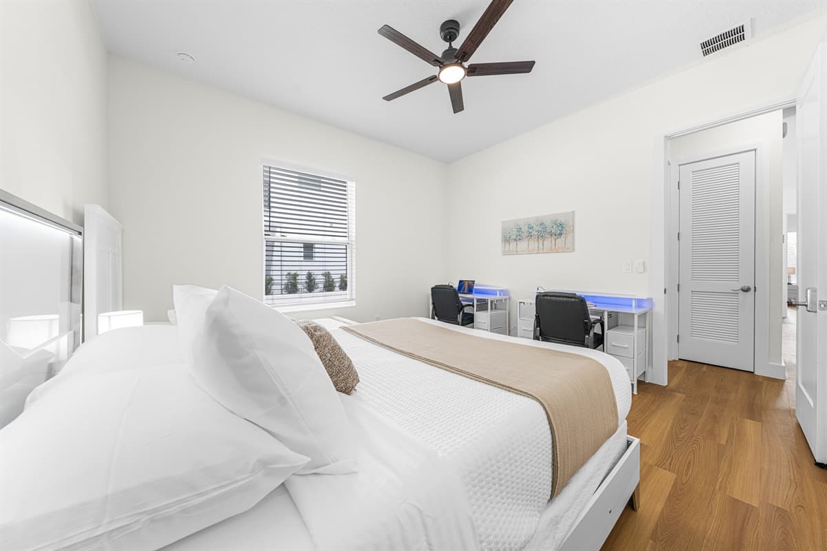Spacious bedroom with multiple beds and workspace—ideal for families or groups.
